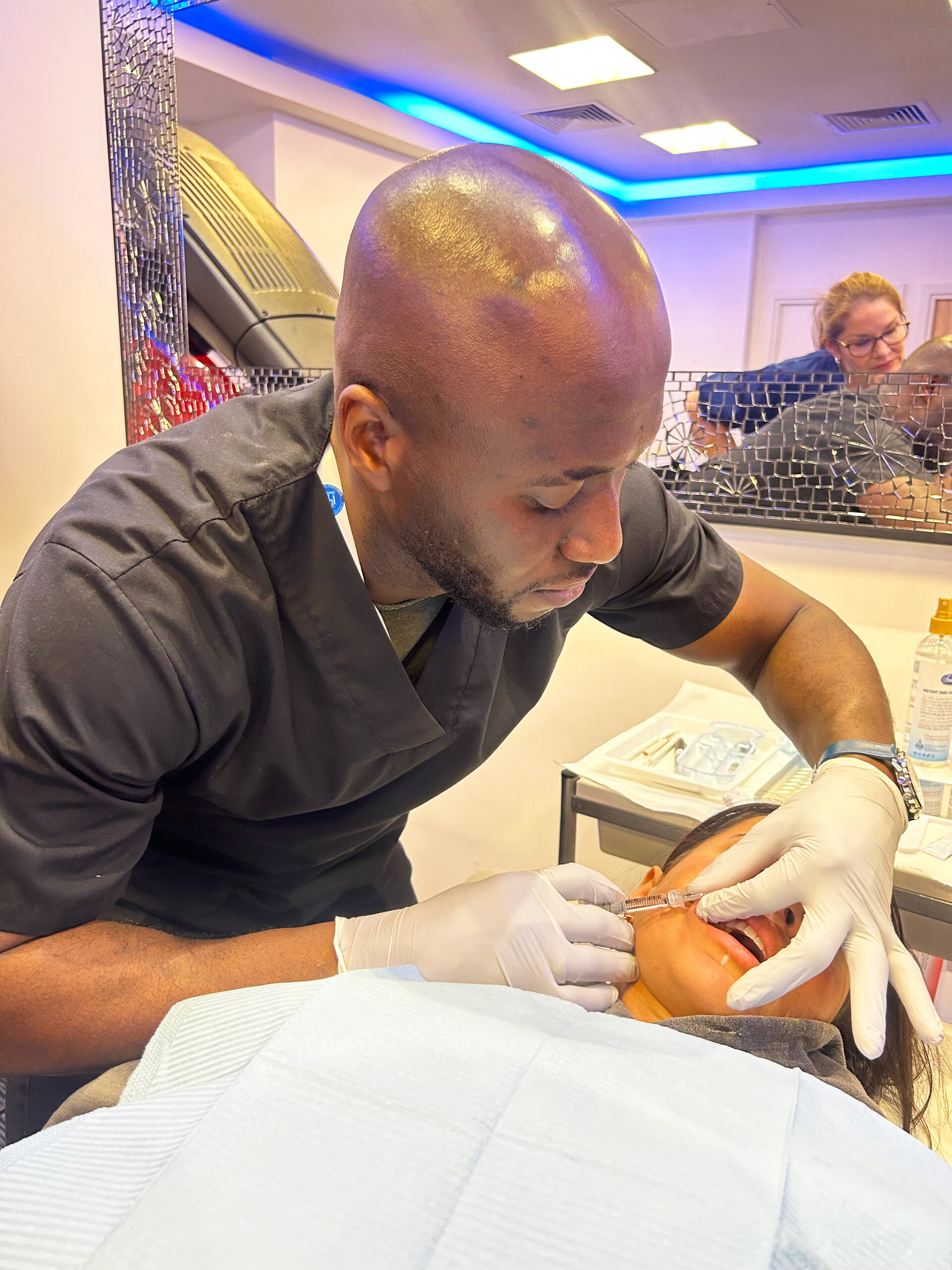 A doctor on a training course performing dermal filler treatment