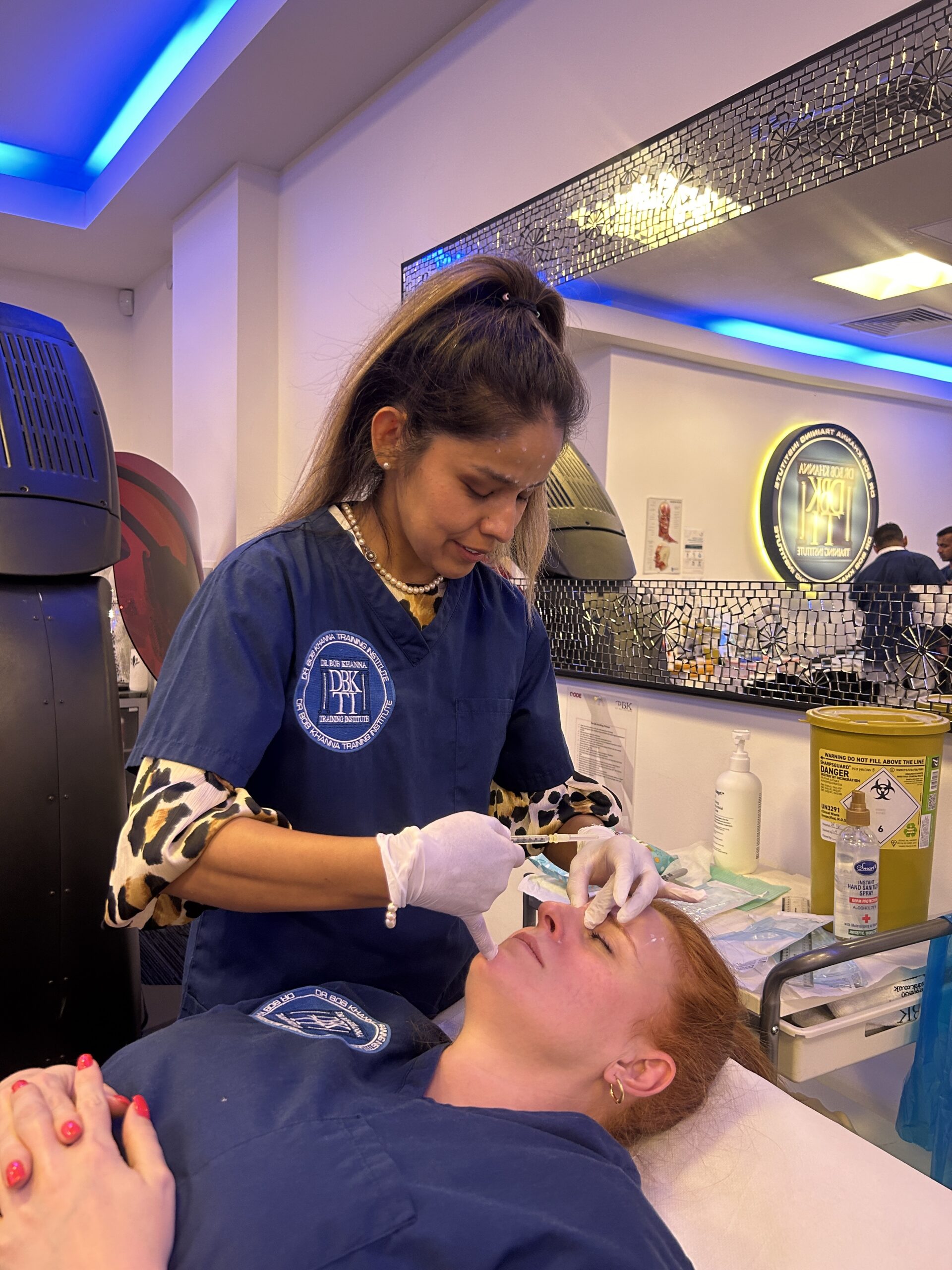 A doctor on a training course performing aesthetic treatment