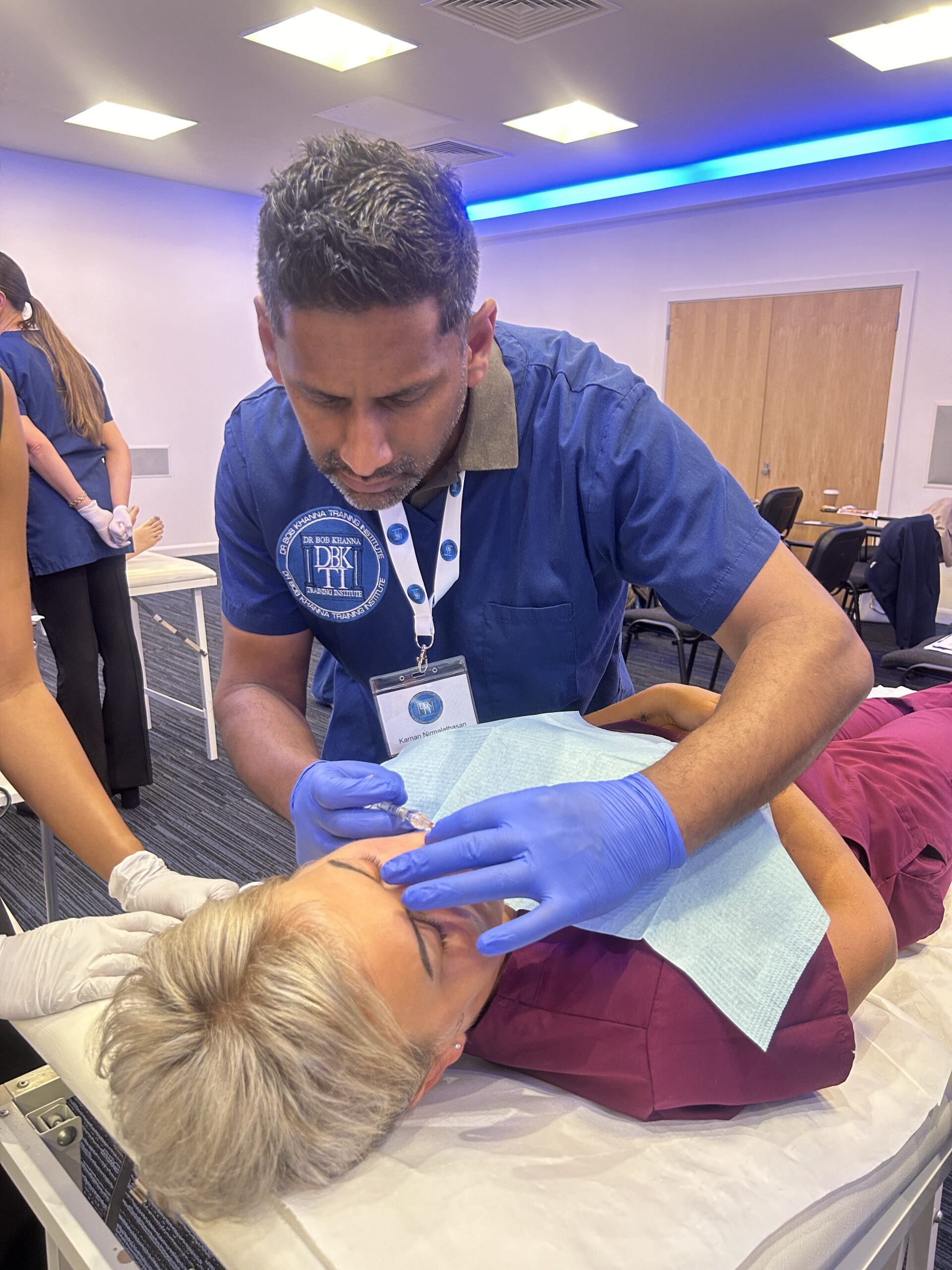 A doctor on a training course performing aesthetic treatment