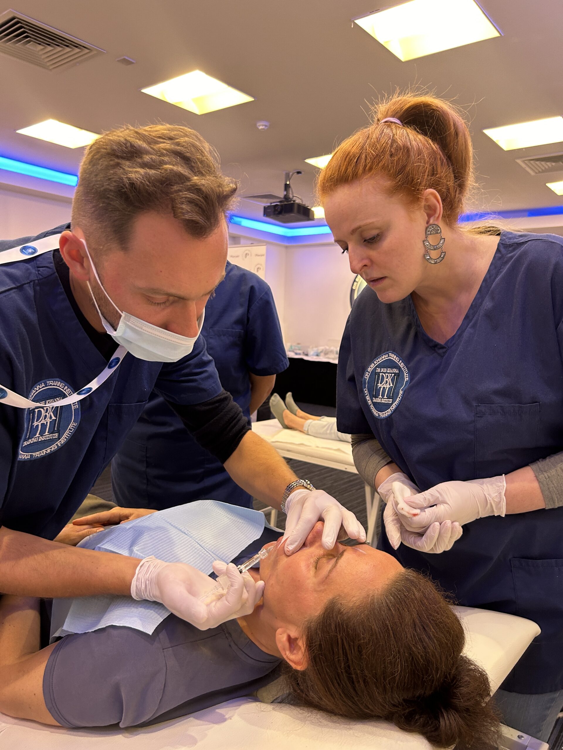 A doctor on a training course performing aesthetic treatment