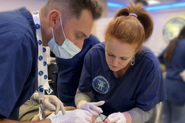 Man and woman injecting another woman