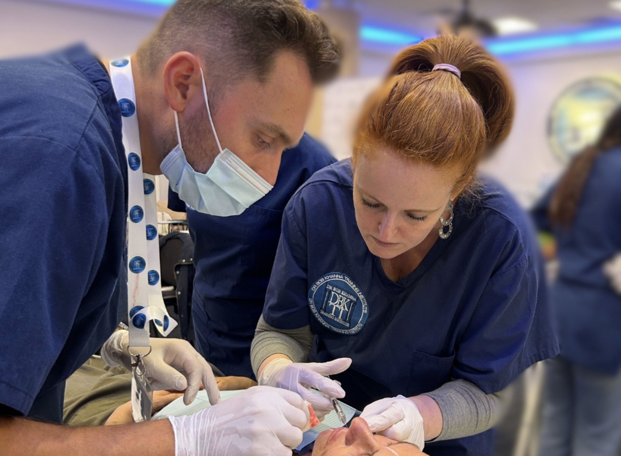 Man and woman injecting another woman